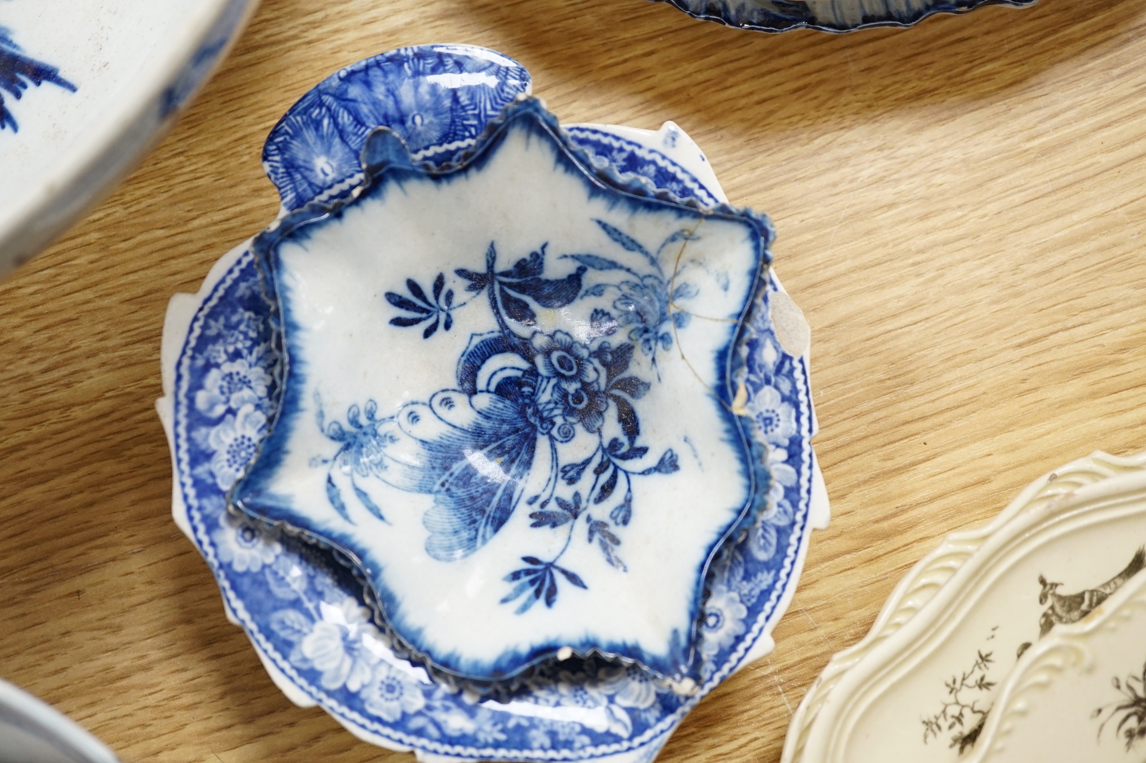 A collection of late 18th/early 19th century pearlware and creamware including three black transfer printed creamware plates, c.1780, blue and white bowls, plates, dishes and jug, the largest 27cm in diameter